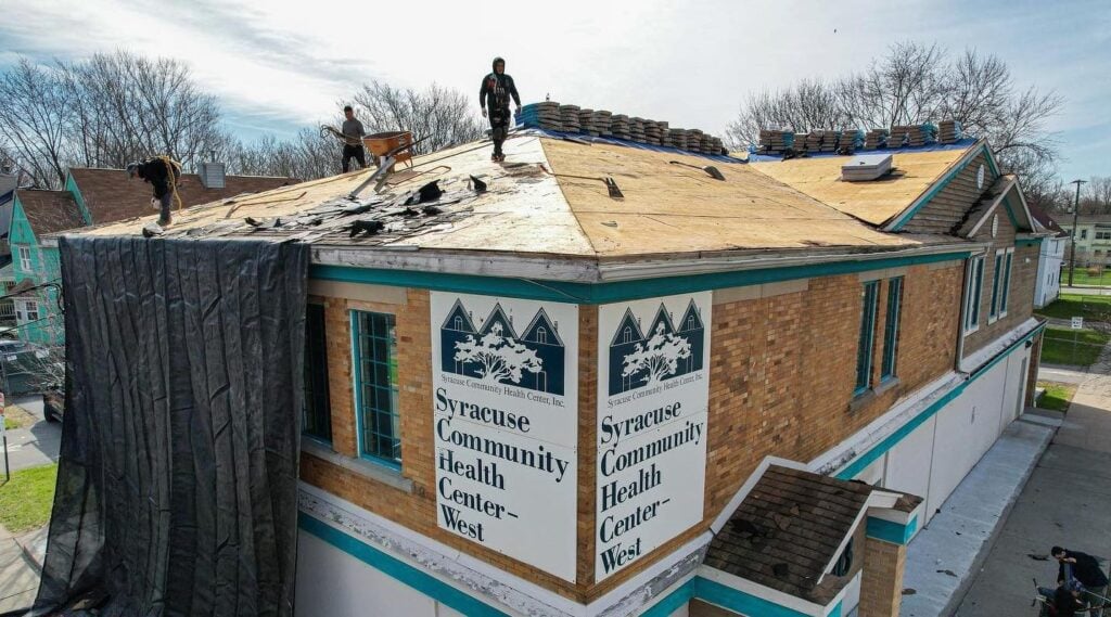 Melo roofing crew working on an asphalt shingle commercial roof replacement